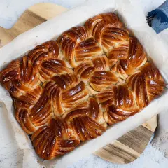 Nybakade, gyllene bullar som precis kommit ut ur ugnen. Doften sprider sig i köket.