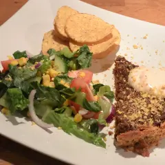 En bit tacopaj med en fräsch sallad till, toppad med krutonger och en klick krämig sås.