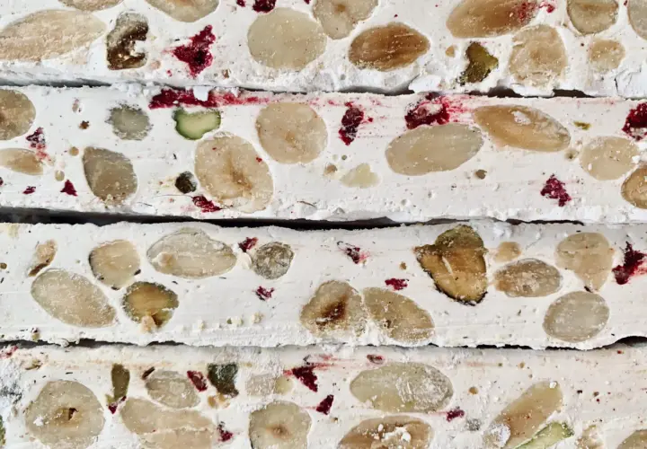 Nära bild av fransk nougat med mandlar, pistagenötter och torkade bär.