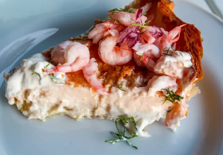En generös bit räkpaj med krämig fyllning, toppad med saftiga räkor och en hint av västerbottensost.